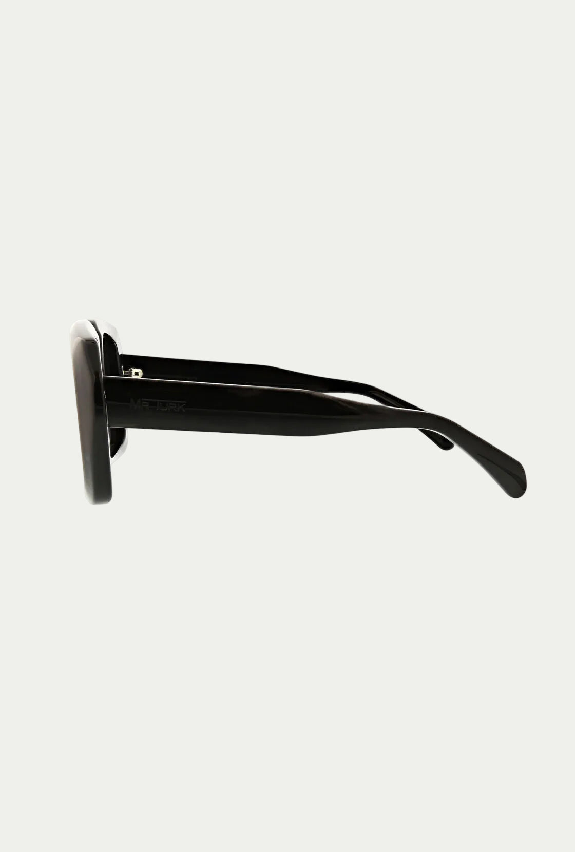 Side view of Andros Sunglass—black, bold acetate frame with thick arms against a white background. Offers 100% UVA/UVB eye protection.