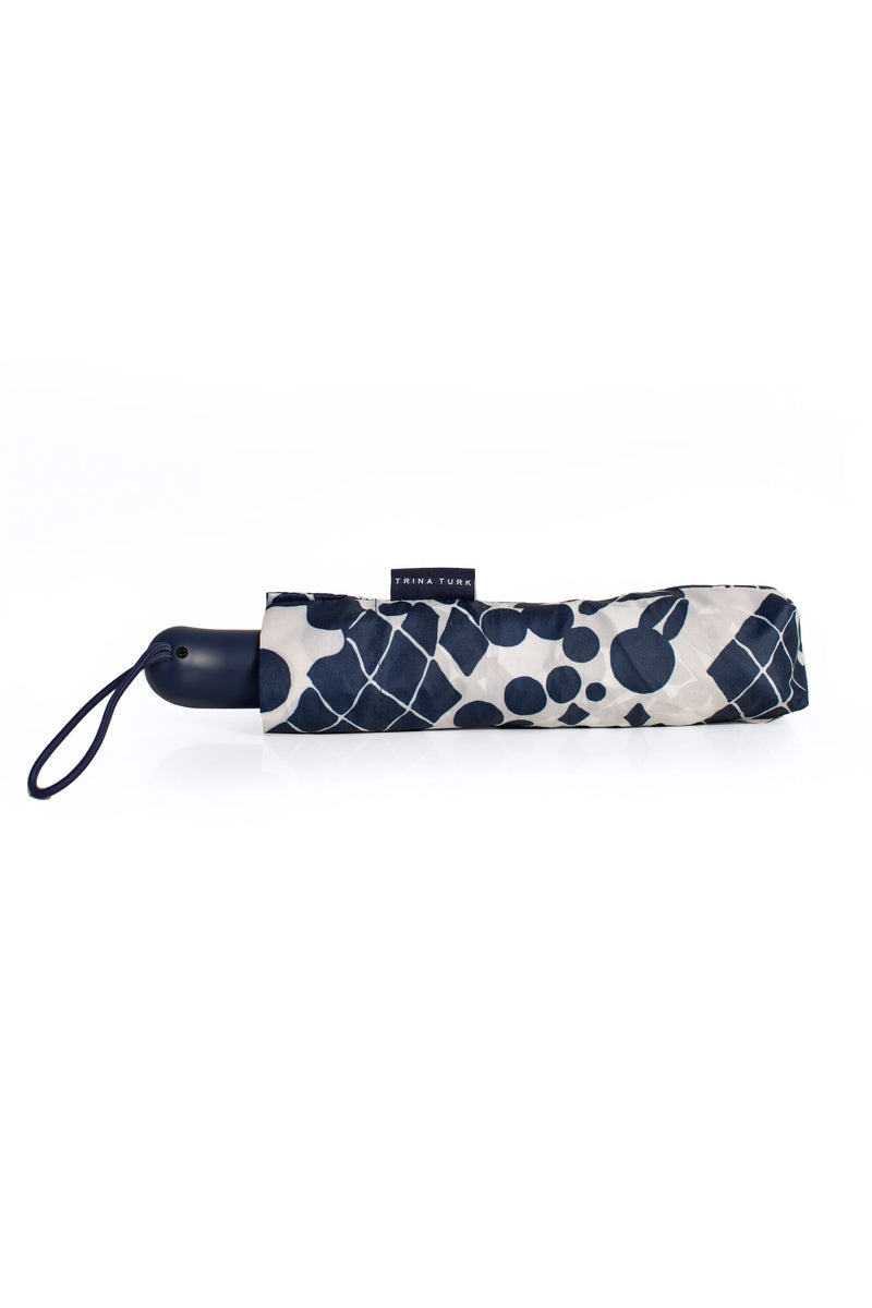 BALI BLOSSOM UMBRELLA in a pair of shoes on a white surface 